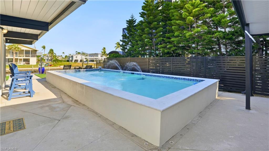 View of swimming pool with a patio area - Virtually Edited Image