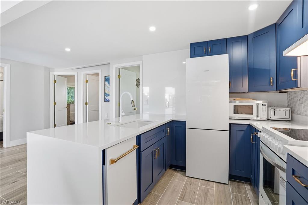Bosch kitchen features a full quartz accent wall and breakfast bar - Virtually Edited Image