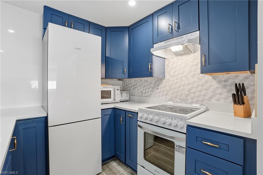 Bosch kitchen features a full quartz accent wall and breakfast bar - Virtually Edited Image