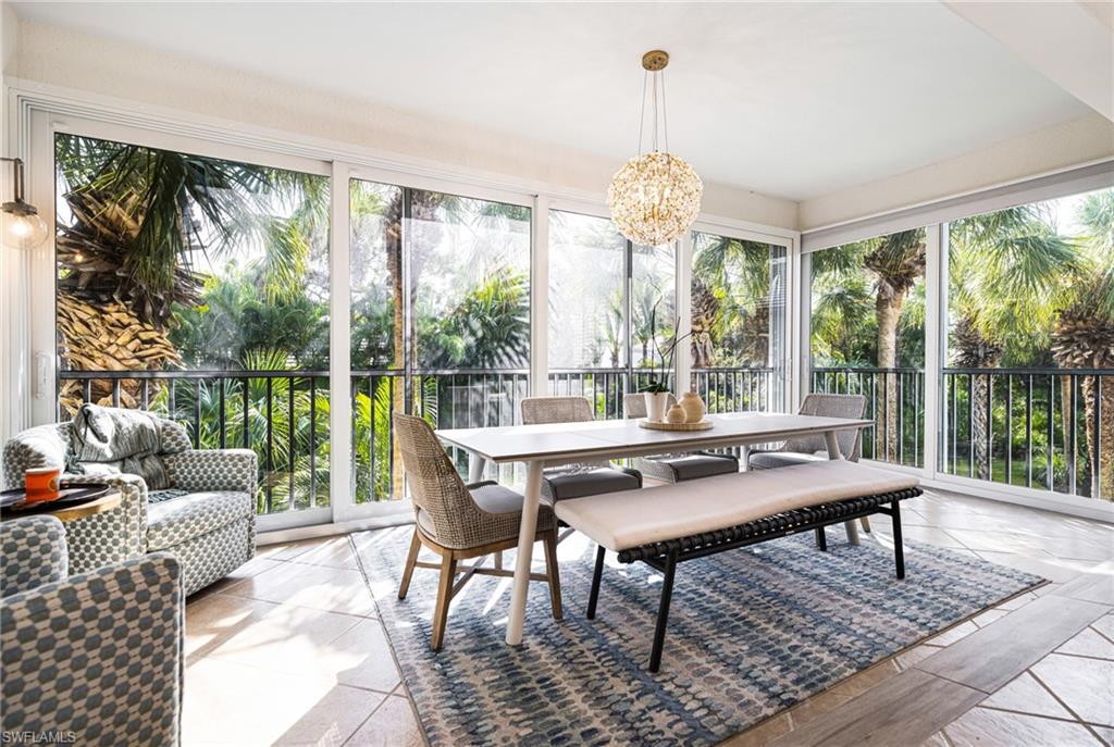 Sunroom featuring an inviting chandelier