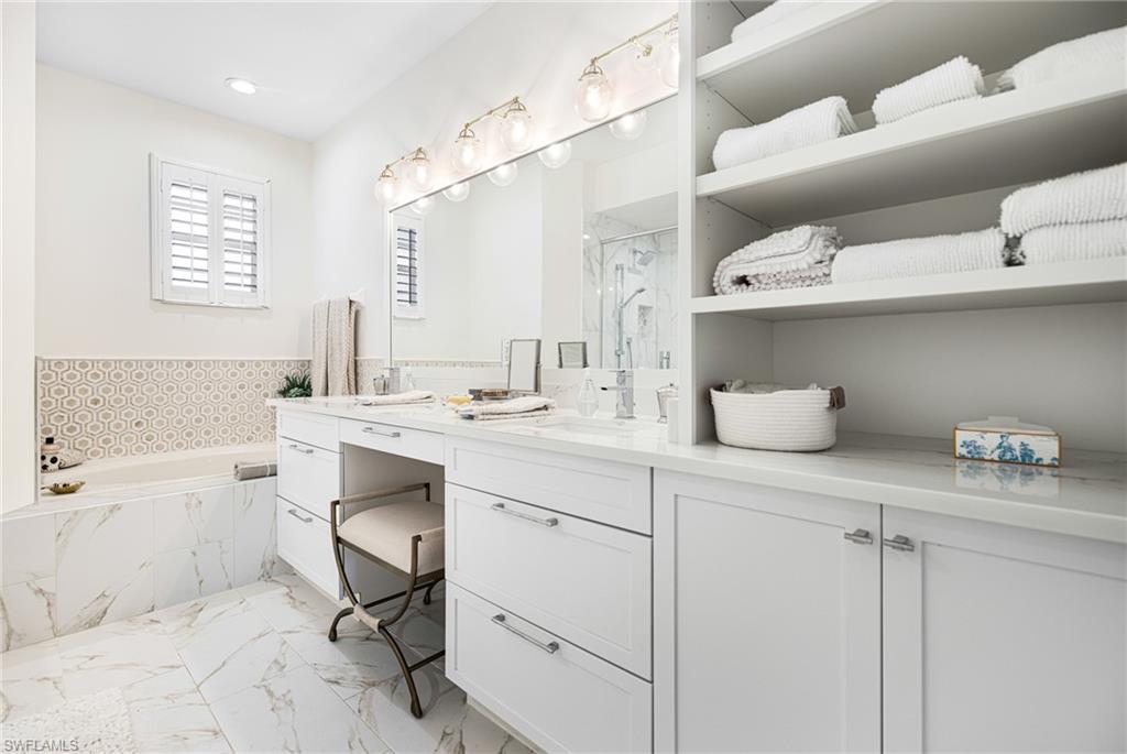 Bathroom with vanity and separate shower and tub