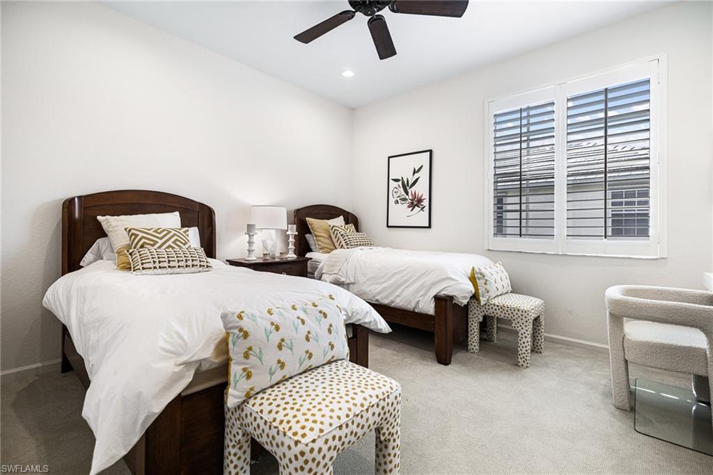Carpeted bedroom with ceiling fan
