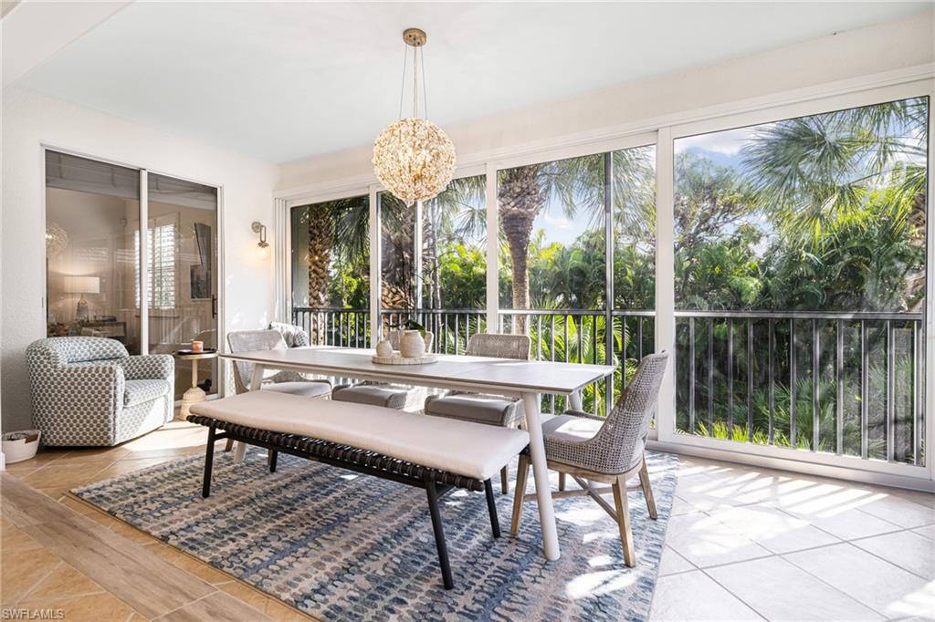Sunroom / solarium featuring an inviting chandelier