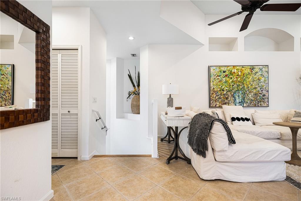 Bedroom featuring light tile patterned flooring, ceiling fan, and a closet
