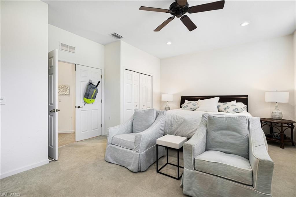 Bedroom featuring light carpet and ceiling fan