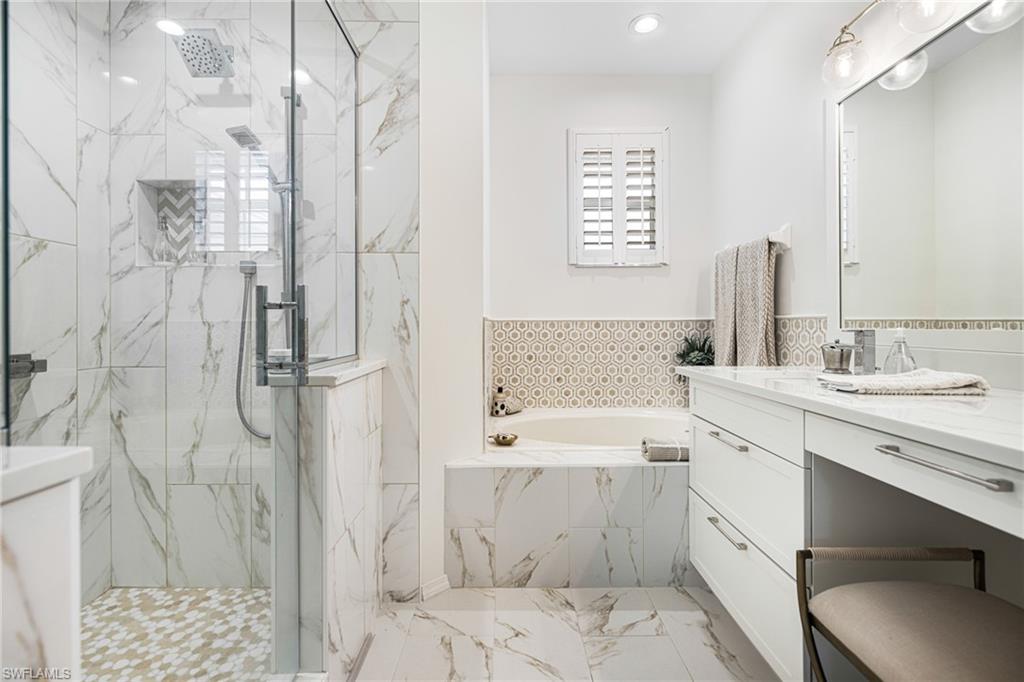 Bathroom featuring independent shower and bath and vanity