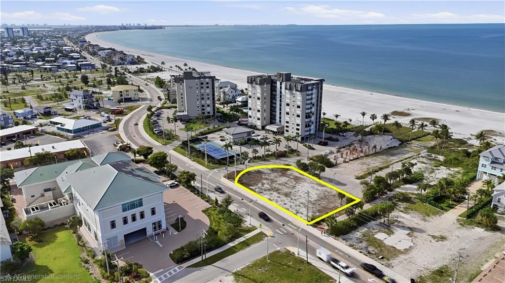 Expansive undeveloped lot featuring direct access to a paved road, positioned across from a sandy beach, with the ocean beyond - Virtually Edited Image