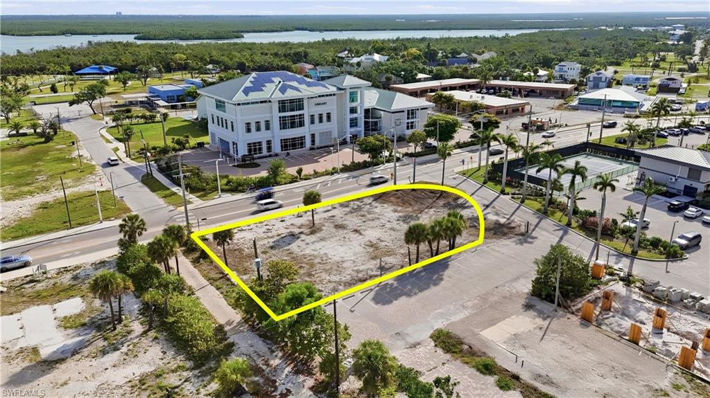 Cleared lot with prominent street frontage and mature palm trees - Virtually Edited Image