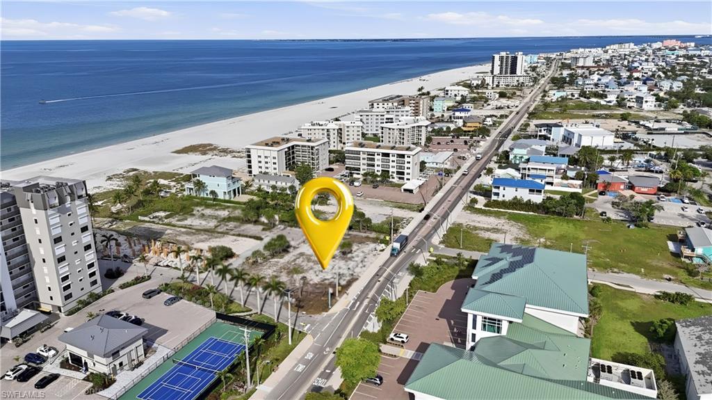 Aerial perspective showcasing coastal proximity, white sand beach, and expansive blue waters - Virtually Edited Image