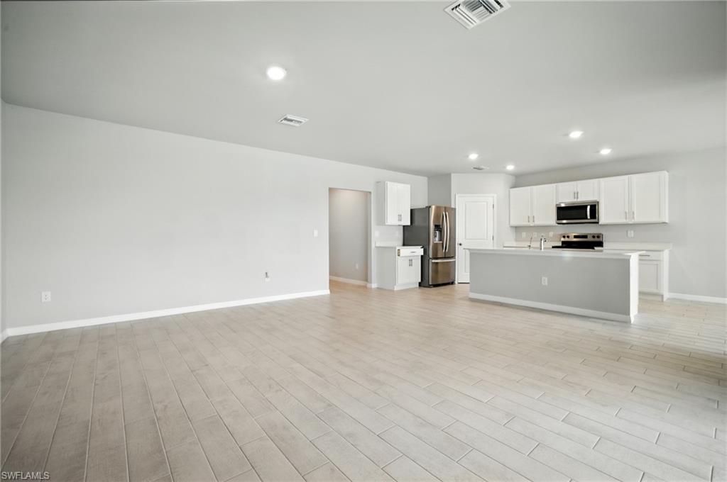 Open concept living area featuring wood-finish flooring