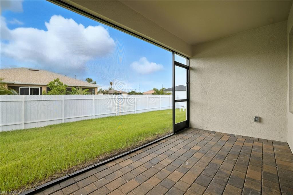 Screened patio featuring multi-toned paver flooring and textured stucco walls