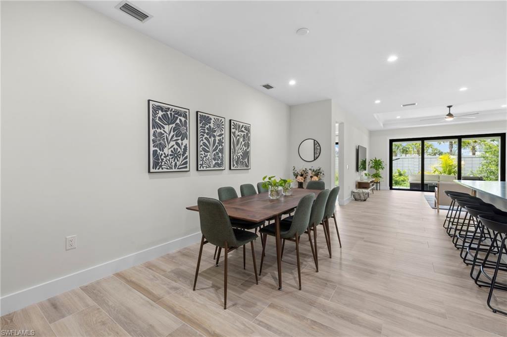 Open-concept interior featuring light wood-finish flooring throughout