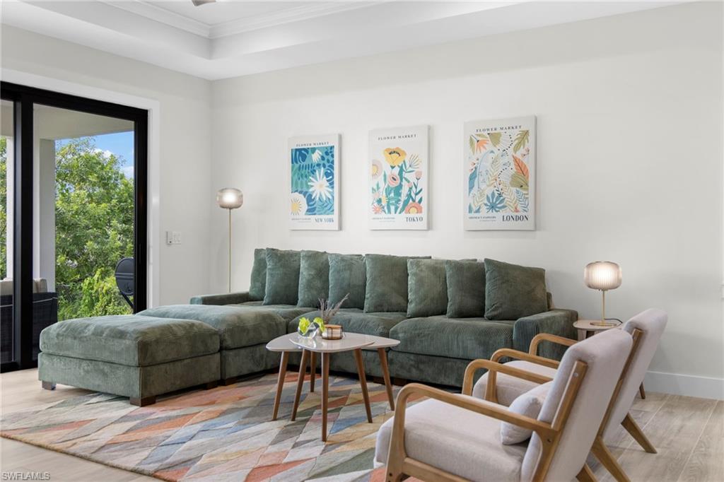 Living area with light wood-finish flooring and white walls