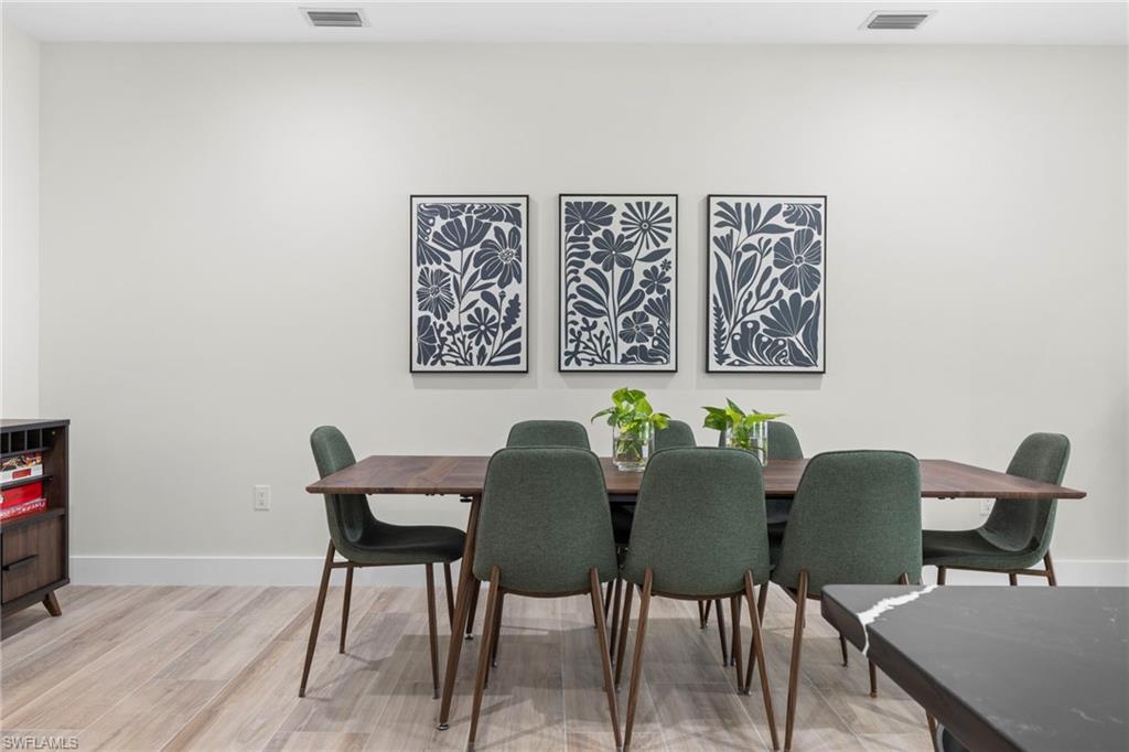 Bright interior space featuring light-toned walls, recessed lighting, and wood-finish flooring