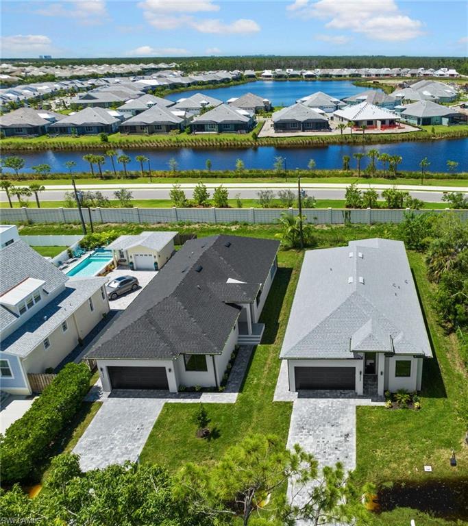 Modern single-story residence featuring a dark shingle roof and a paver driveway