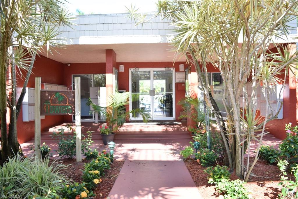 Entryway featuring a red exterior, white trim, and glass doors