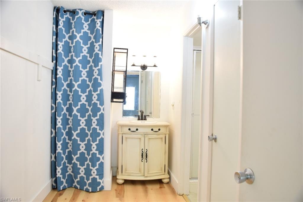 Bathroom vanity featuring a vessel sink with a dark faucet