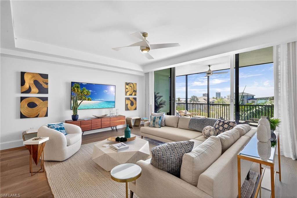 Spacious living area featuring expansive large glass floor to celling sliding doors allowing for great natural lighting