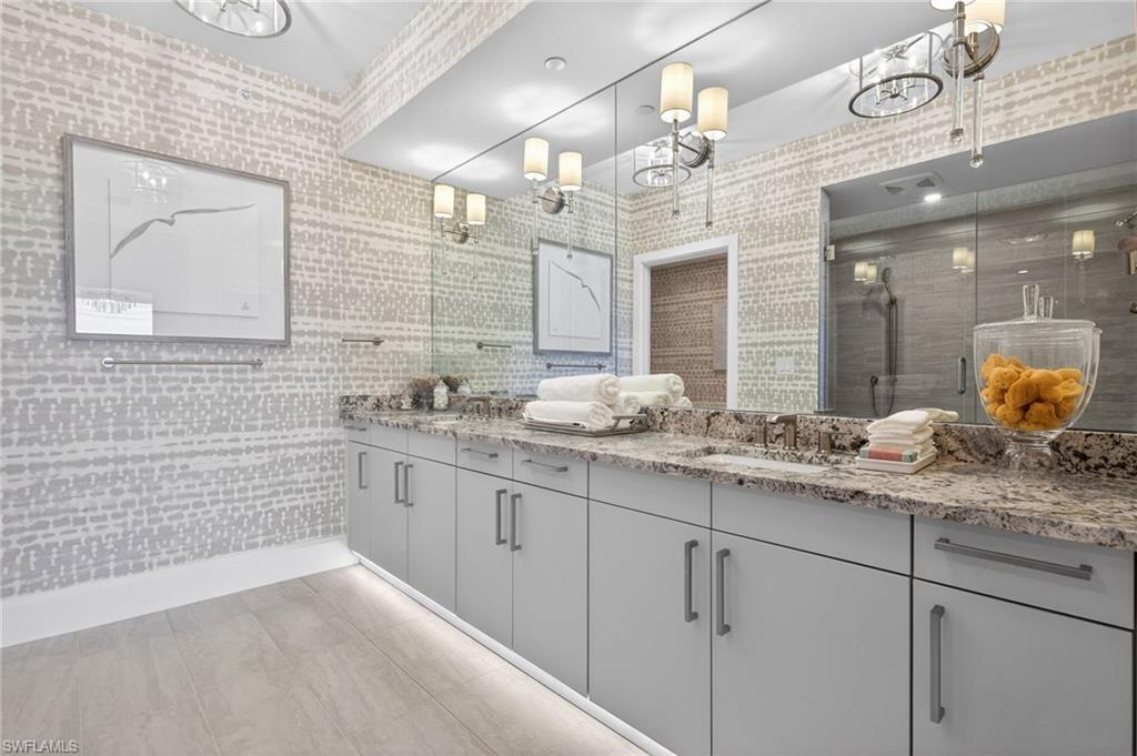 Master suite bathroom has dual vanity with undermount sinks and extensive granite countertops