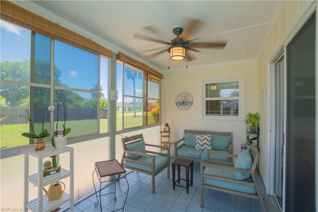 Sunroom / solarium with a ceiling fan, plenty of natural light, and an outdoor hangout area