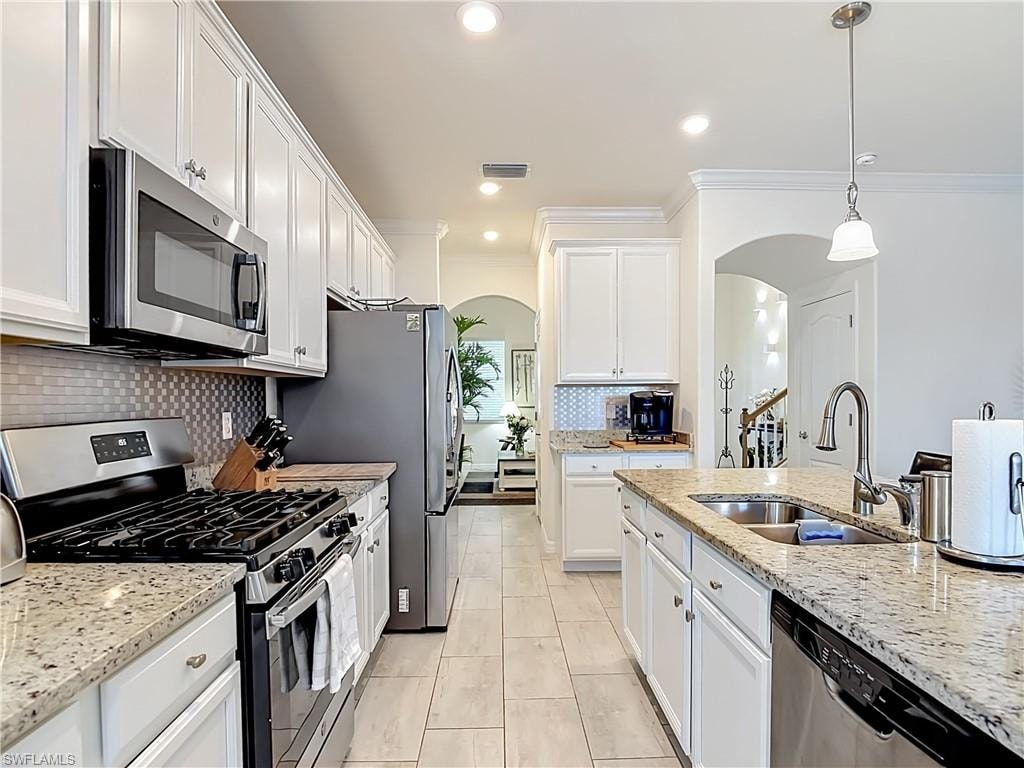 Kitchen with white cabinetry, stainless steel appliances and granite countertops