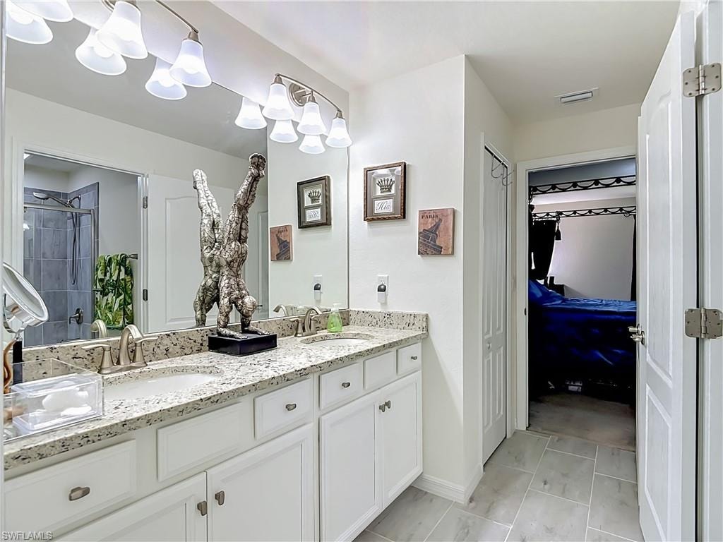 2nd floor Jack and Jill Bathroom featuring a tub/shower combination with a Granite Countertop and dual sinks.  Bedrooms #2 and #3 share this Bathroom