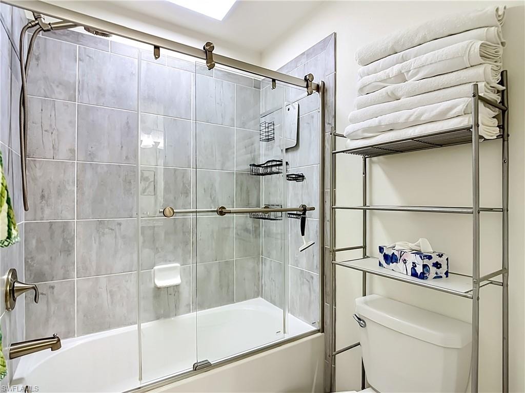 2nd floor Jack and Jill Bathroom featuring a tub/shower combination with sliding glass doors.  Guest Bedrooms #2 and #3 share this Bathroom