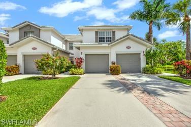 Traditional-style home featuring concrete driveway, stucco siding, an attached garage, and a front lawn