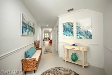 Corridor featuring baseboards and finished concrete floors