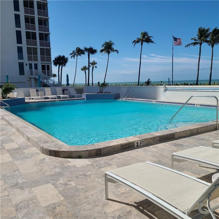 Community pool with a patio