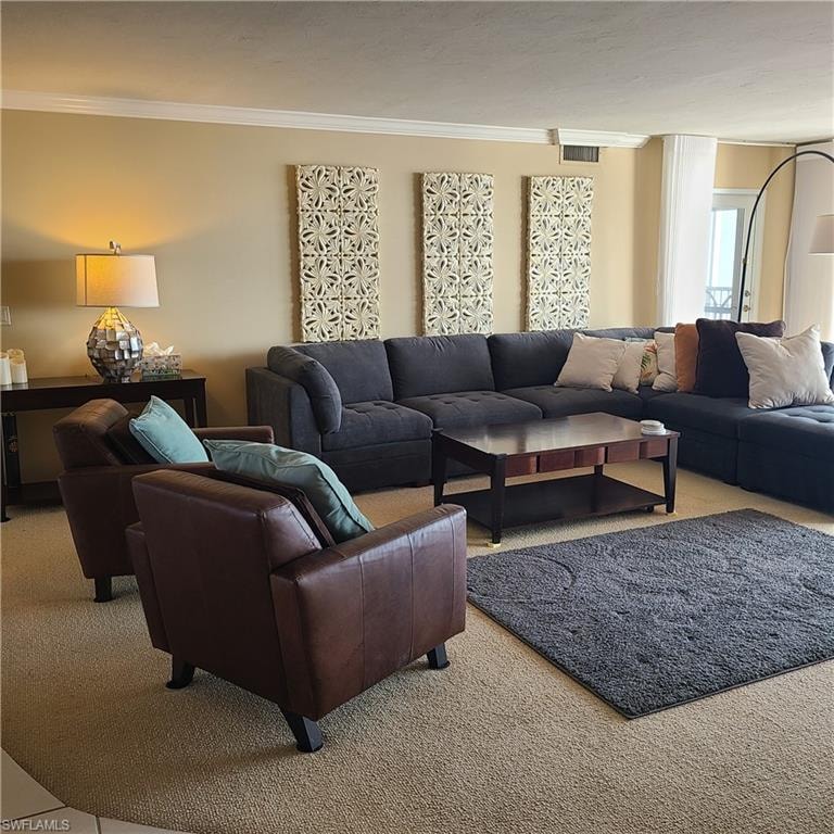 Living room with crown molding and light colored carpet