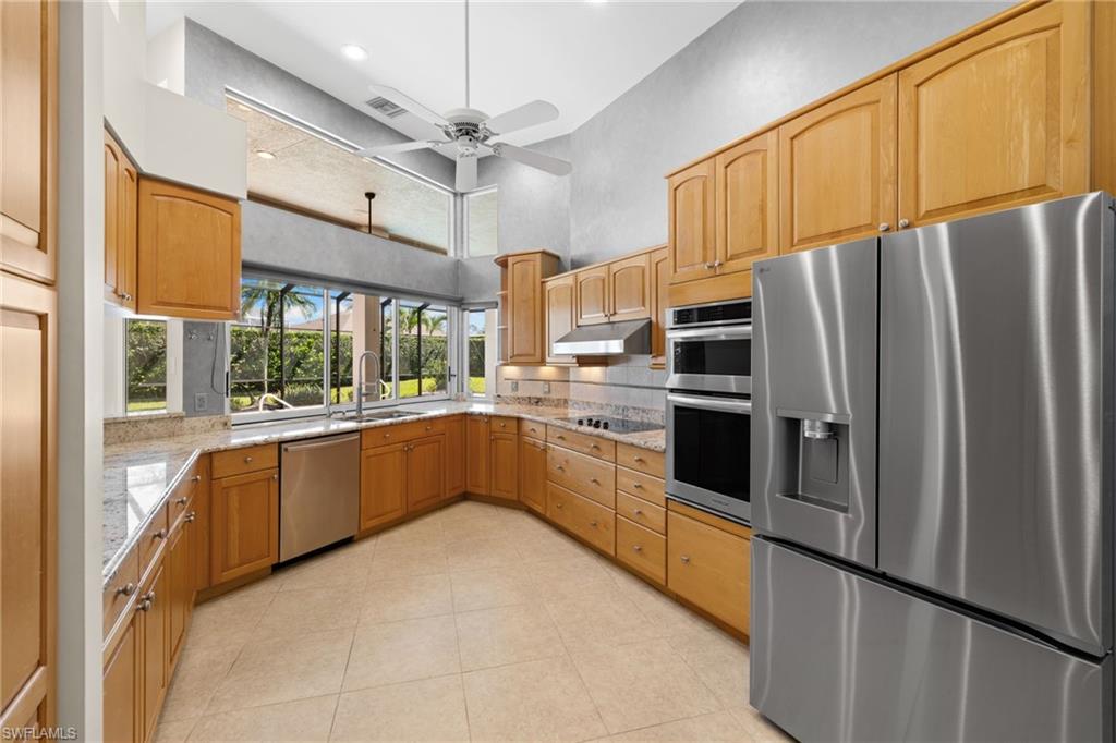 Kitchen featuring extensive wood cabinetry, stainless steel appliances, and a double oven