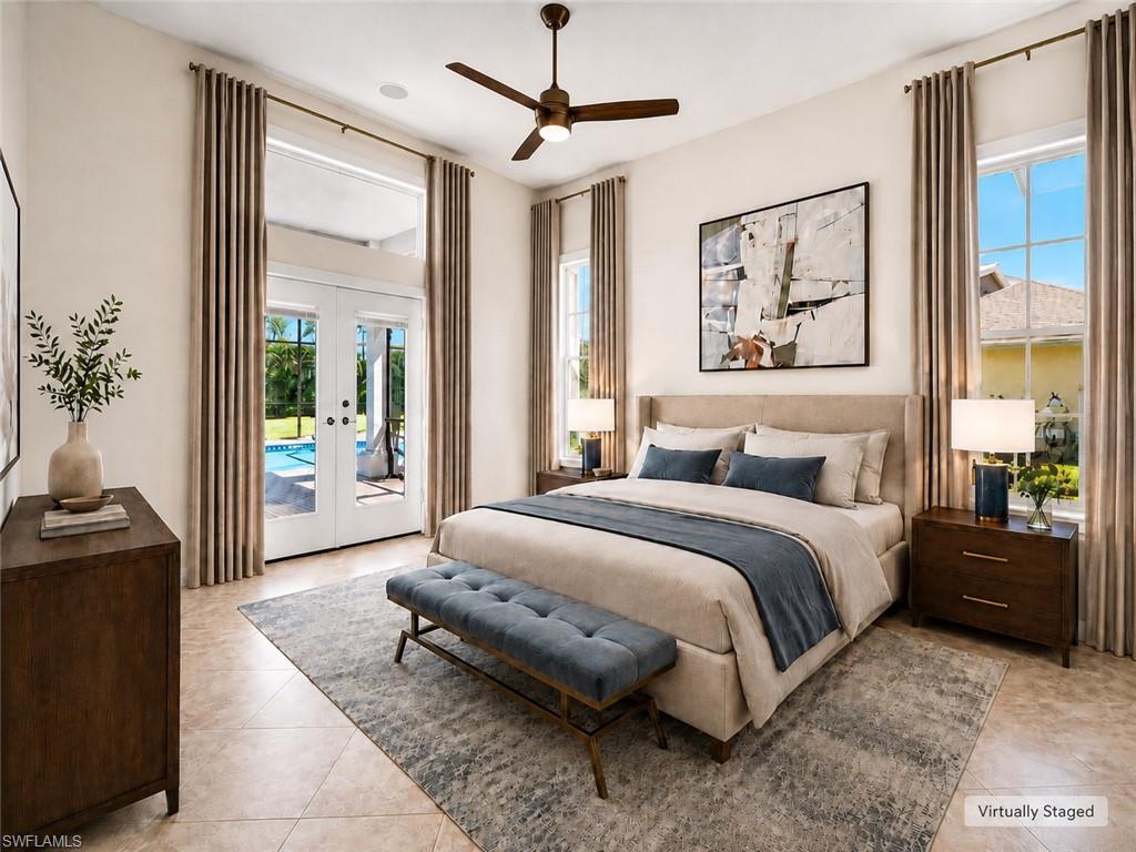 Room featuring tiled flooring, a ceiling fan, and direct access to a patio with a swimming pool via French doors