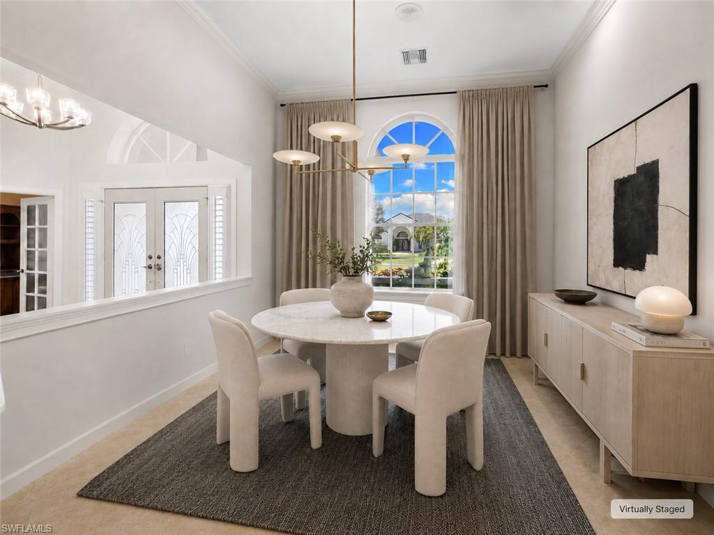 Dining area featuring a large arched window with drapes, a modern chandelier, and tile flooring