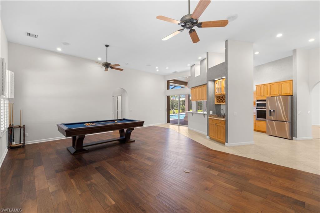 Spacious interior with vaulted ceilings and wood-finish flooring