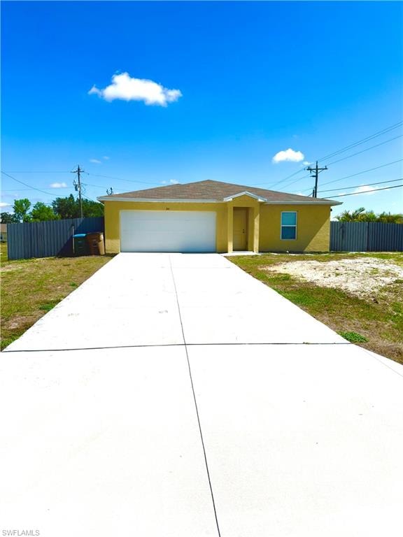Single-story residence featuring a yellow exterior, an attached garage with a white door, and a brown shingle roof