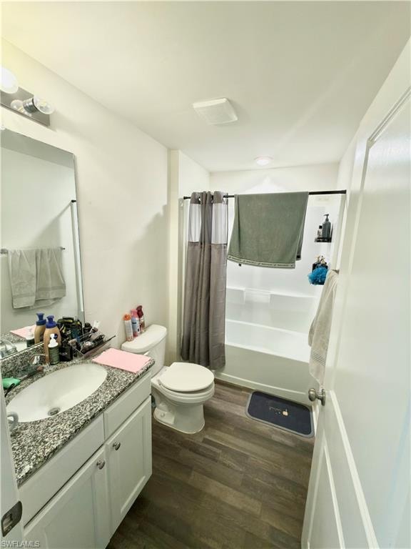 Bathroom featuring a white vanity with a speckled countertop, a drop-in sink, and white cabinetry