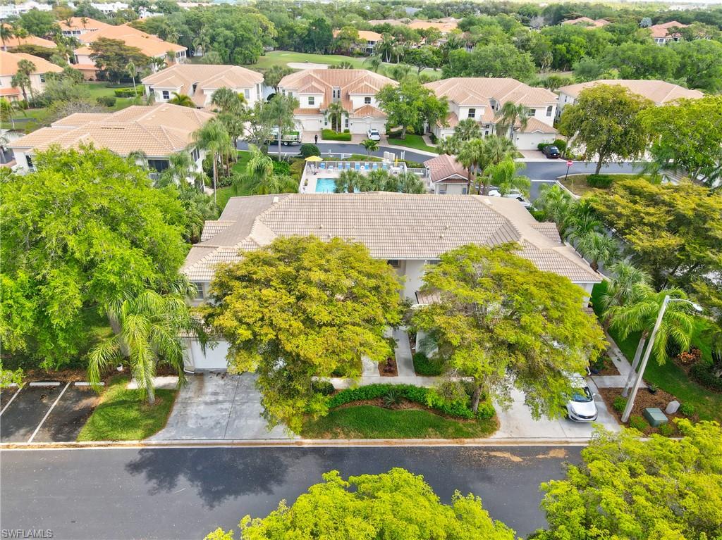 Aerial view of residential area featuring a tree filled landscape