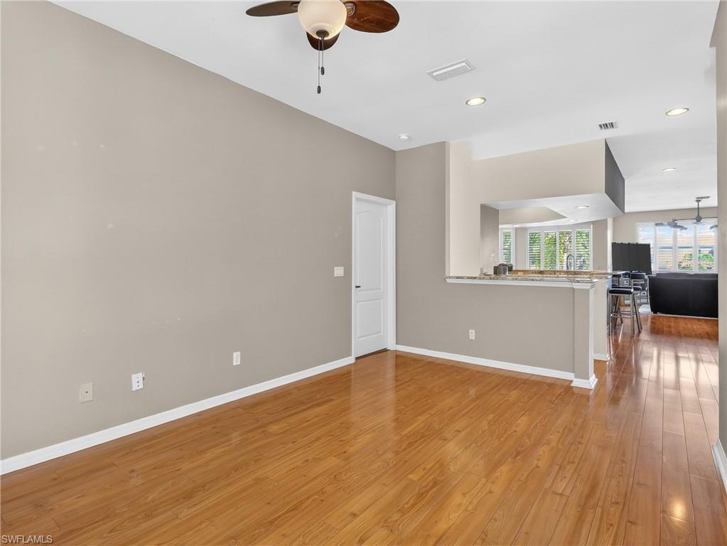 Den with ceiling fan, light wood finished floors, and recessed lighting
