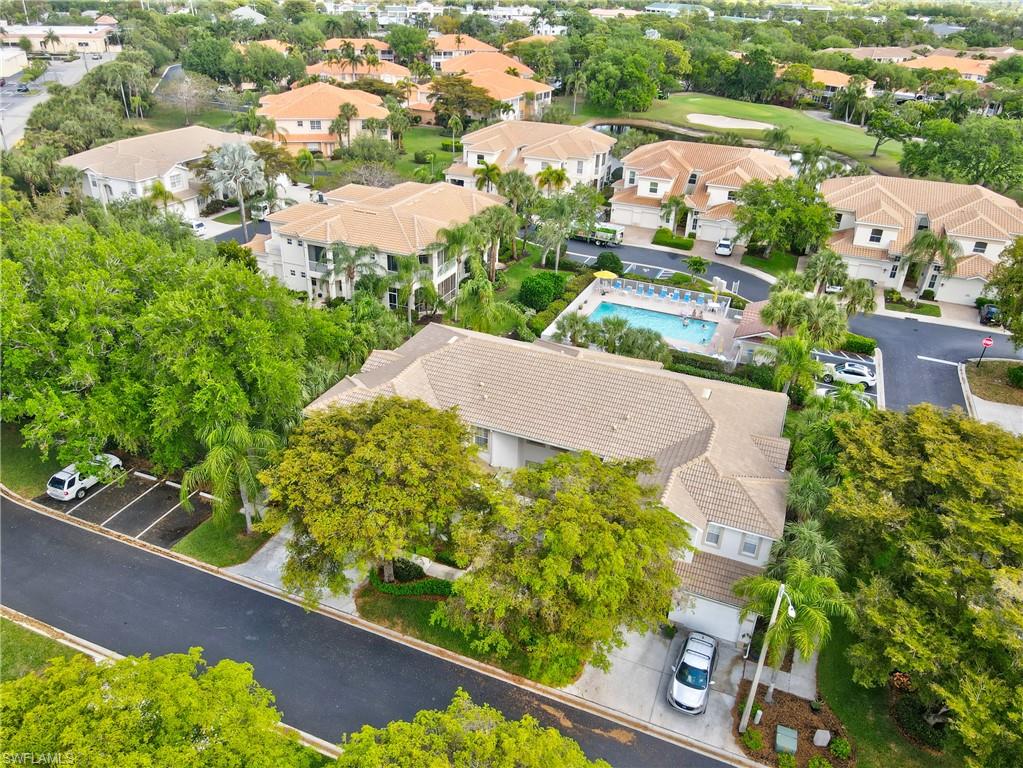 Aerial perspective of suburban area featuring a pool