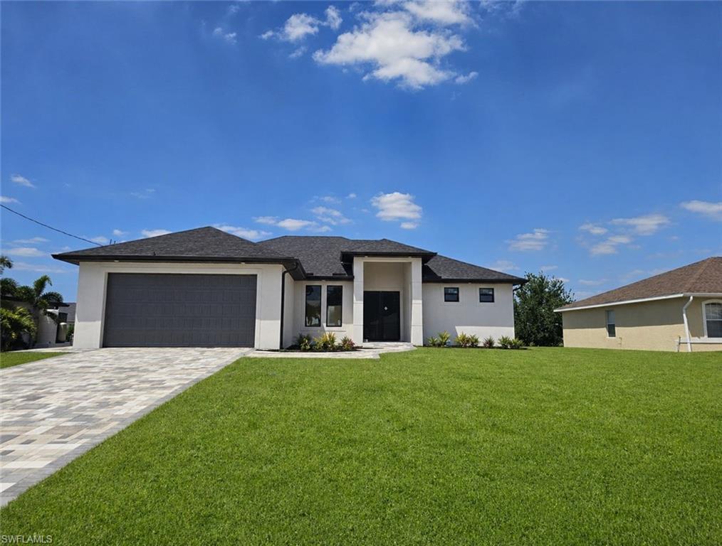 Contemporary single-story residence featuring a dark shingle roof, white stucco exterior, and a two-car garage with a dark gray door