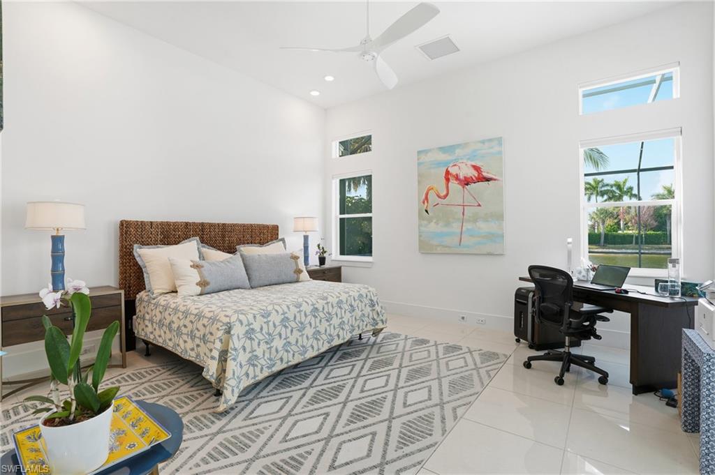 Spacious room featuring high ceilings, recessed lighting, and white tile flooring