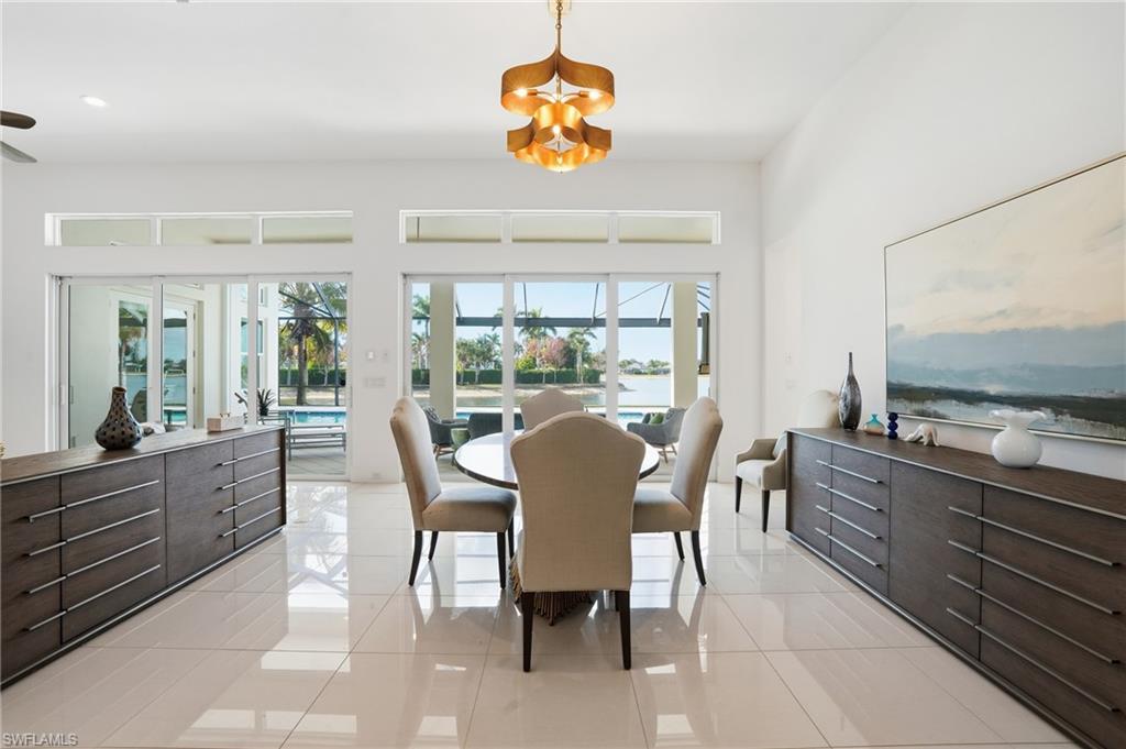 Spacious interior featuring high ceilings, large format tile flooring, and extensive glass doors and transom windows