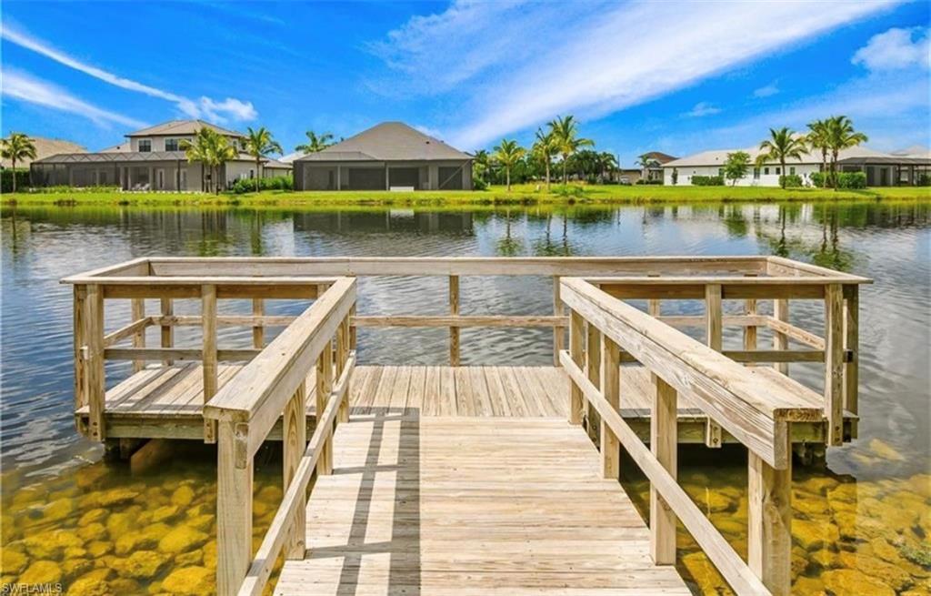 Wood dock structure extending into the lake, featuring a clear water edge with visible rock features