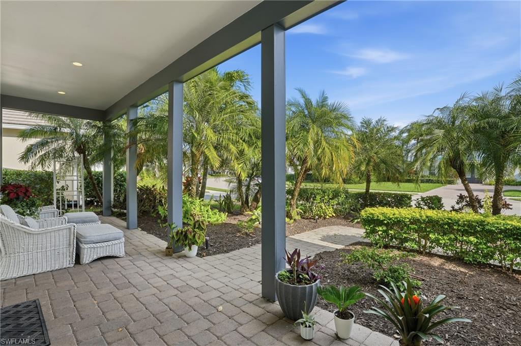 Covered patio featuring paver flooring, recessed lighting, and structural pillars
