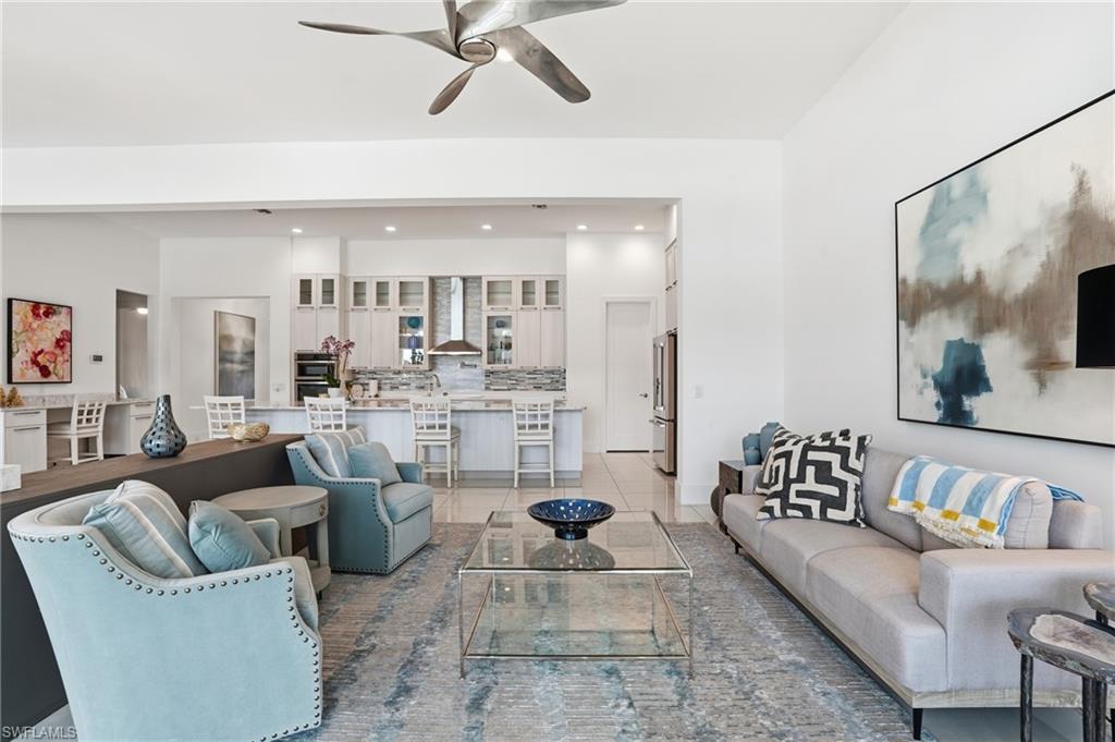 Spacious living area featuring high ceilings and light-toned flooring
