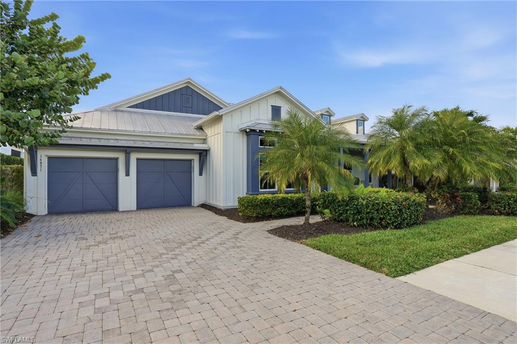 Coastal-inspired exterior with white board-and-batten siding and blue accents