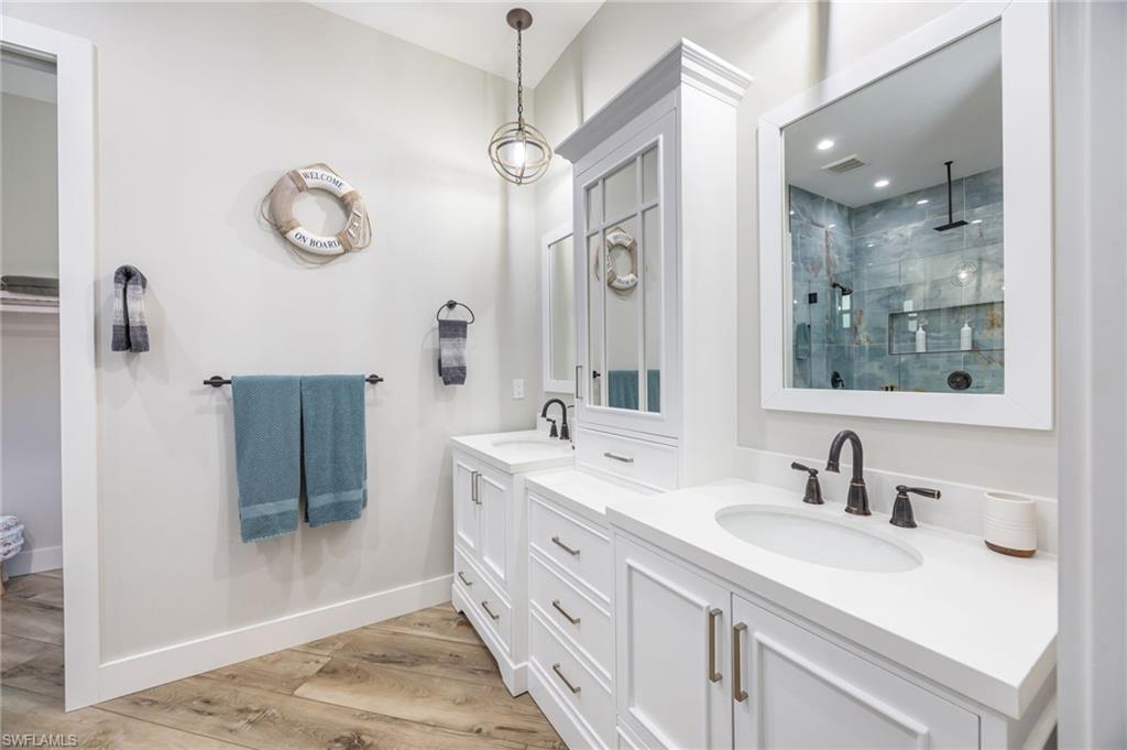 Dual vanity with white cabinetry and integrated sinks, complemented by dark bronze fixtures