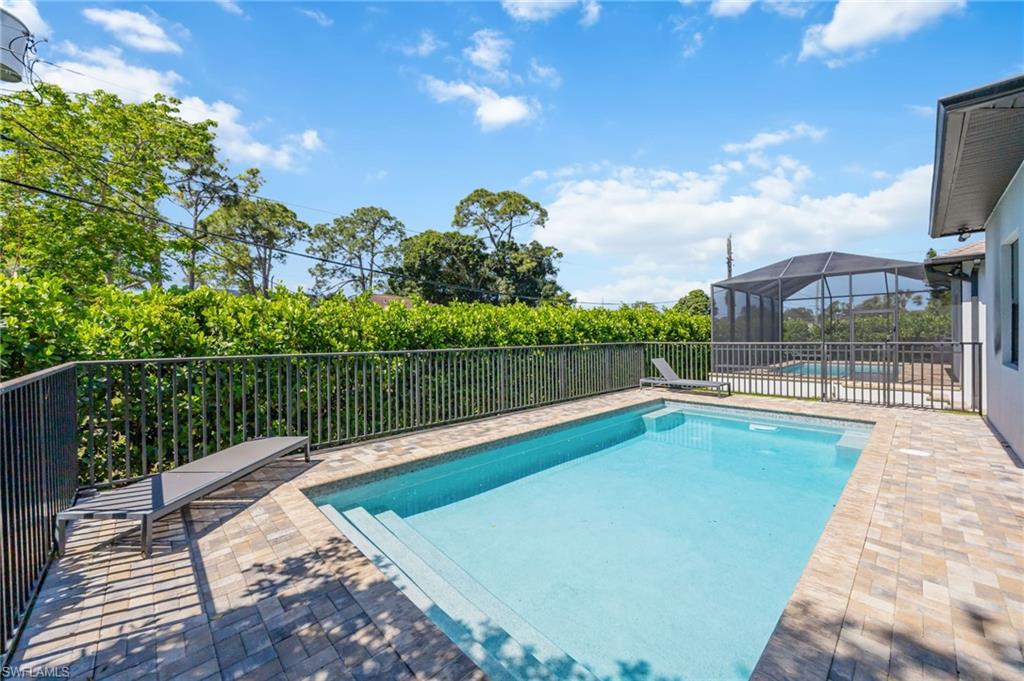 Rectangular swimming pool with integrated steps, surrounded by paver patio surfacing