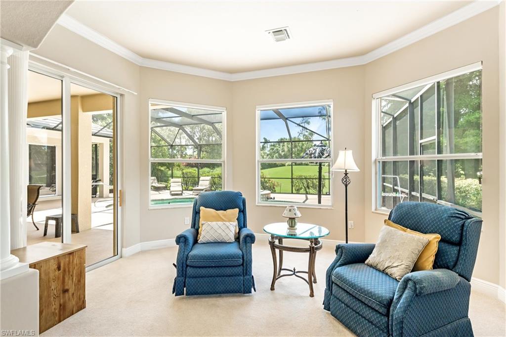 Primary Bedroom featuring large windows and glass sliding doors, providing access to an exterior screened patio